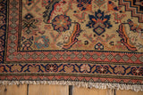 Antique Malayer rug corner, showing terracotta diamond border, Herati main field, and fringe.