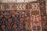 Antique Persian Malayer rug border detail, with geometric patterns in raspberry, orange, and sky blue.