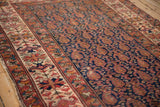 Malayer rug's navy boteh field and intricately patterned ivory, raspberry border.