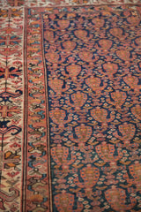 Detailed view of antique Malayer rug's rich navy field, alternating botehs, intricate borders.