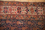 Antique Malayer rug border detail showing geometric ivory patterns, and navy field with softened tones.
