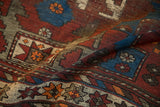 Stepped geometric motifs in sapphire blue, black cherry red, and tangerine wool pile.