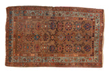 Antique Kurdish Hamadan rug, allover floral trellis on camel ground, with blue and madder red borders.