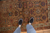 Antique Kurdish Hamadan allover floral and vine pattern in camel, indigo, madder, with abrashes.