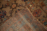 Hand-knotted foundation, floral pile, and worn fringe of an antique Kurdish Hamadan rug.