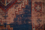 Antique Caucasian rug's navy and black cherry red geometric hook and latch motif and wear.