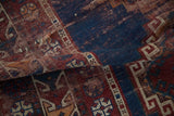 Folded antique Caucasian runner, navy blue, red, ivory geometric hook and latch patterns, visible pile wear.