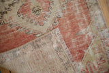 Visible foundation and fringe detail on a distressed blush Oushak rug runner.