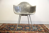 Elephant grey fibrous Eames LAX Rope Edge chair on a blue Persian Hamadan rug.