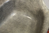 Close-up of elephant hide grey fiberglass shell with visible fibrous swirls on Eames chair.