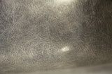 Fibrous elephant grey fiberglass texture on the Eames chair shell.