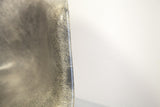 Fibrous elephant hide grey Eames chair shell, showing visible fiberglass swirls.