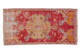 Vintage distressed Oushak rug runner fragment, cherry red field with a geometric saffron medallion.