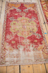 Distressed red and ivory vintage Oushak runner showing fringe and exposed foundation.