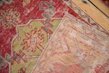 Distressed red and green Oushak pile, showing foundation, reverse, and fringed end.
