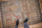Distressed Sivas rug corner, displaying worn pictorial panels in beige, terracotta, and powder blue.