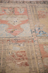 Distressed pile of a vintage Turkish Sivas rug with beige, terracotta, and blue pictorial panels.