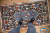 Decorative distressed Oushak runner with faded blue and tangerine geometric patterns, underfoot.
