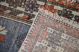 Vintage Oushak rug runner's hand-knotted foundation, fringed edge, and worn pile texture.
