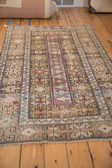 Detail of distressed Melas rug, geometric dragon and plant motifs in beige, blush.