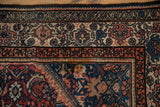 Corner of vintage Malayer rug with pale rose borders and dusty sapphire Herati field details.