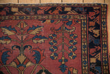 Antique Lilihan rug's upper corner, primitive germinating tree of life and navy border with wear.