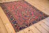 Antique Lilihan rug corner, dusty raspberry field, primitive floral designs, navy border, and even knot head wear.
