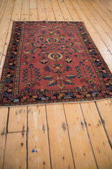 Antique Lilihan rug detail: primitive floral germinating tree-of-life motifs, dusty raspberry, navy.
