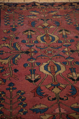 Primitive floral tree of life motif with even wear in cochineal red, navy, and beige.