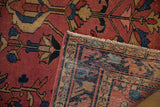 Antique Lilihan hand-knotted rug fold: red, navy, beige border pattern with visible foundation and selvage.