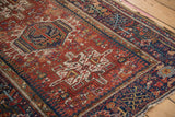 Geometric navy blue border with rectilinear tree-of-life patterns on vintage Karaja rug.