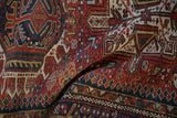 Vintage Karaja rug showing hand-knotted geometric patterns in cherry red, navy, and pale gold.
