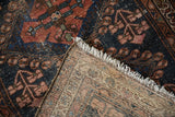 Hand-knotted foundation, side cord selvage, and worn navy-copper pattern of antique Mehriban rug.