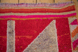 Textured vintage distressed Kurd runner with bold fuchsia, red, and silver serrated patterns.