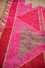 Textured pile of a vintage distressed Kurd rug with fuchsia, pomegranate, and silver geometric serrated patterns.
