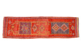 Distressed Kurd runner, decorative geometric diamond motifs in burnt orange and aubergine.
