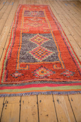 Distressed vintage Kurd runner's fringed end, showcasing striped border in orange, ruby, and pale jade tones.