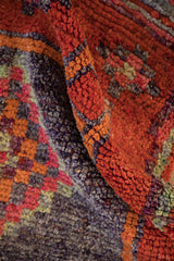 Bright burnt orange, aubergine, and jade green distressed Kurd runner pile texture.
