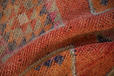 Textured short pile of the distressed Kurd runner, showing coral, orange, and silver abrashes.