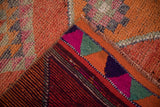 Detail of a vintage distressed Kurd runner's colorful Kilim end and textured short pile.
