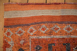 Close-up of the hand-knotted Kurd runner's secured edge, burnt orange, and ivory pile.