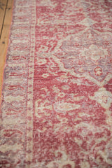 Distressed Turkish Sparta rug detail showing faded raspberry and ivory tones, visible foundation wear, and secured side.