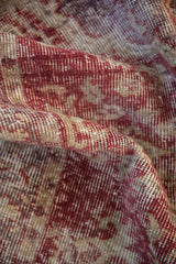 Distressed vintage Sparta rug showing rich raspberry pile and faded ivory foundation.