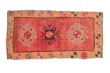 Distressed Kars rug mat with triple medallion, weaver inscription, and vibrant red floral border.