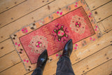 Distressed vintage Kars rug mat with grapefruit red field, tangerine border, and fuchsia accents.