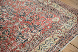 Distressed Turkish Sparta carpet section with faded red, charcoal palmettes and worn ivory border.