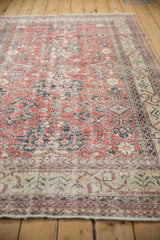 Distressed vintage Sparta rug with faded brick red palmettes and ivory pattern detail.