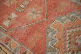 Distressed Kurd runner pile detail, revealing faded tangerine, rust, and oxidized silver motifs.
