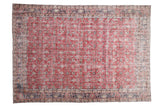 Distressed cherry red vintage Sparta carpet, faded scrolling vinery, time-softened blue floral borders.