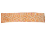 Vintage distressed Kurd runner with a diamond lattice pattern in faded tangerine, beige, and dusty magenta.